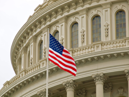 American flag flying in front of a federal courthouse, symbolizing federal authority in ERISA preemption and PBM regulation