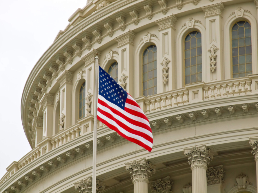 American flag flying in front of a federal courthouse, symbolizing federal authority in ERISA preemption and PBM regulation