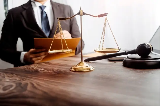 law firm blog A legal blog worthy of our clients, as seen here between an attorney and client at a desk, writing on a pad of lined paper.